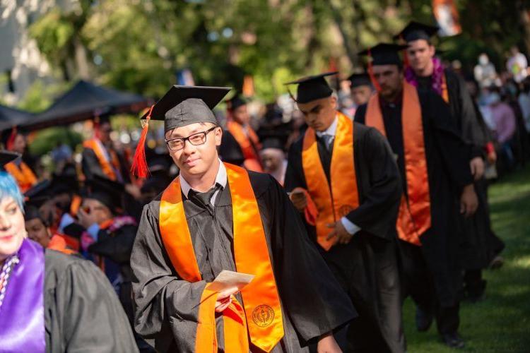 students in caps and gowns at a graduation ceremony